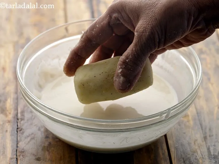 Step 31 – Always remember to roll the croquette in plain flour-water mixture with one hand and in …