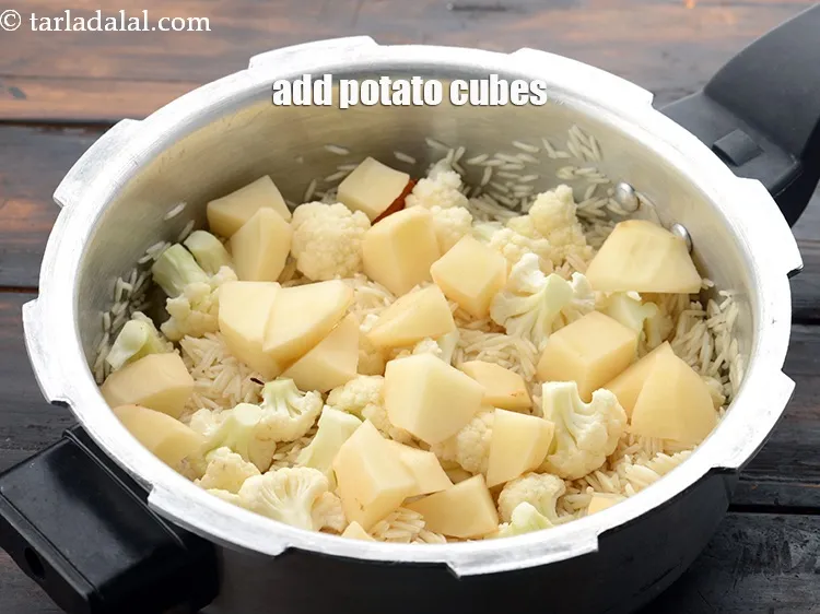 Step 15 – Add 3/4 cup&nbsp;peeled&nbsp;<a href="https://www.tarladalal.com/glossary-potato-cubes-725i">potato cubes</a>.