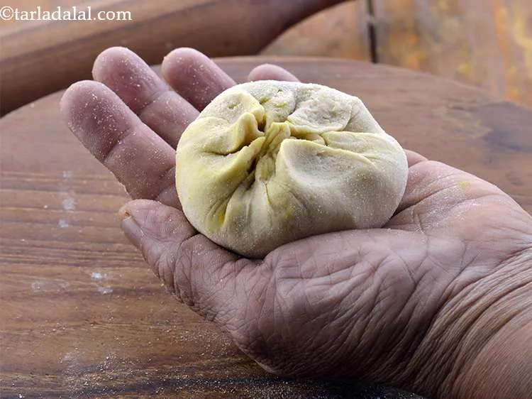 Step 27 – Bring together all the sides in the centre while pushing the stufing down so as …