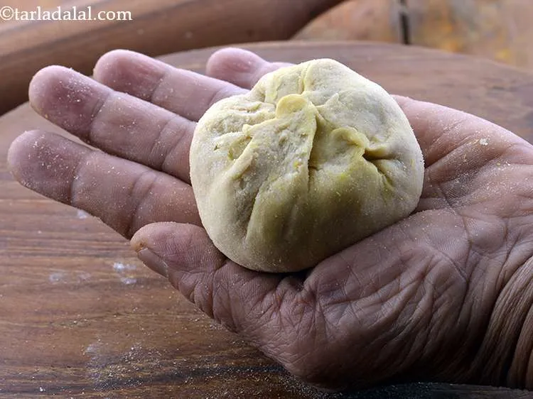 Step 28 – Bring the sides together to form a ball, remove the excess dough and seal it …