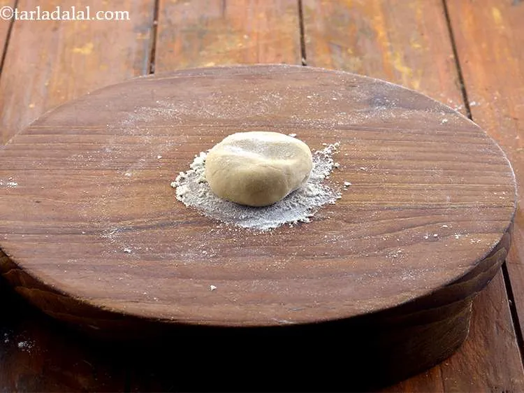 Step 24 – Coat one portion of the dough lightly in flour and flatten it on the rolling …