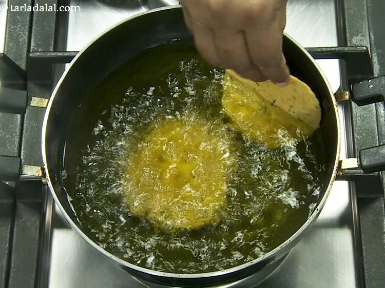 Step 19 – To deep-fry <strong>aloo ki puri</strong>, heat the oil in a deep non-stick pan and drop …