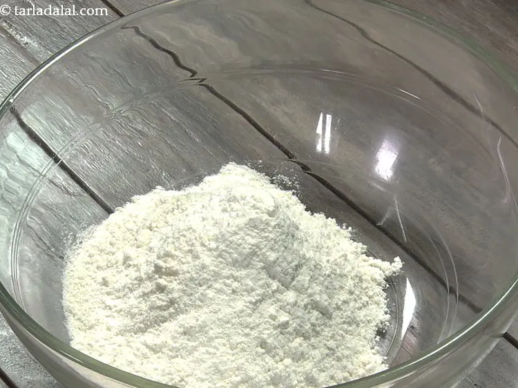 Step 3 – Put plain flour. If using old maida then sift and then add to the dough …