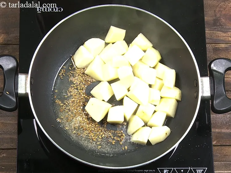 Step 7 – Add 1 1/2 cups&nbsp;<a href="https://www.tarladalal.com/glossary-potato-cubes-725i">potato cubes</a>.