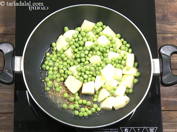 Step 8 – Add 1/2 cup&nbsp;<a href="https://www.tarladalal.com/glossary-green-peas-matar-hare-matar-vatana-180i">green peas</a>. For this recipe, we do not recommend the use of …