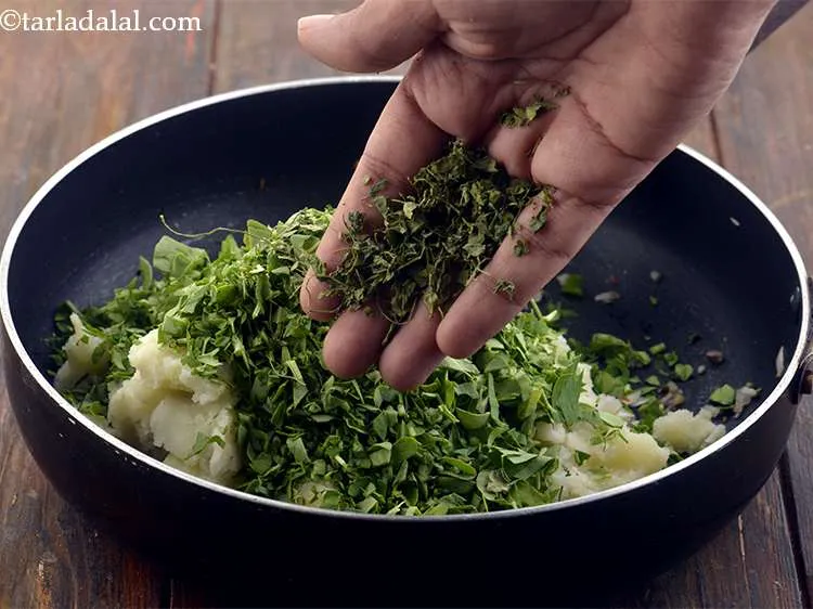 Step 9 – Also add the dried fenugreek leaves. Crush them between your palms and then add them.