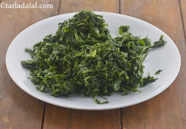 Step 2 – Squeeze out all the water from the fenugreek leaves and keep aside. Discard the squeezed …