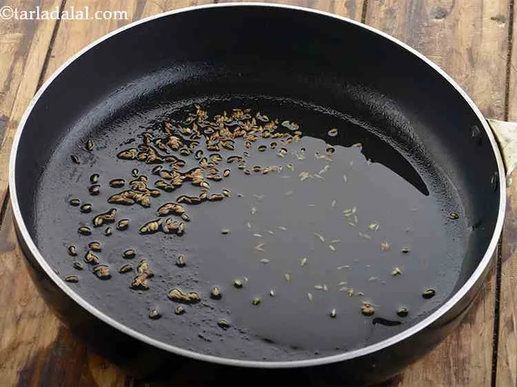 Step 1 – For the <strong>aloo mutter recipe</strong>, heat the oil and add the cumin seeds.