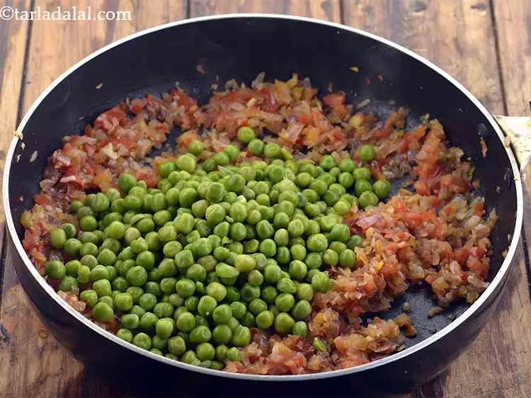 Step 10 – Add the green peas. Learn <a href="https://www.tarladalal.com/How-To-Microwave-Green-Peas-22505r">how to boil mutter in a microwave</a>.
