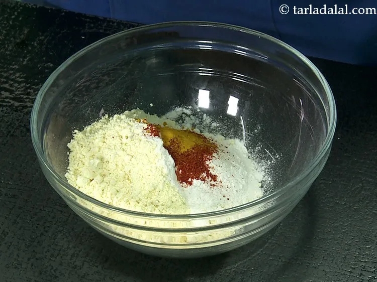 Step 9 – Add turmeric powder to give our besan batter a bright yellow colour.