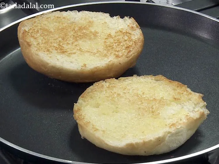 Step 18 – Apply 1 tsp of butter on both the sides of each half of the burger …