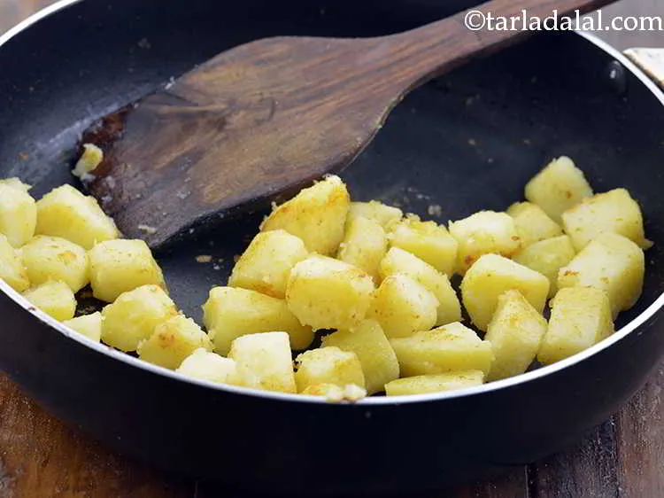 Step 1 – Heat the oil in a broad non-stick pan, add the potatoes, mix gently and cook …