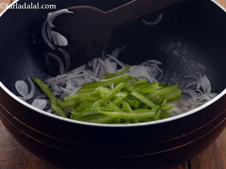 Step 19 – Add the capsicum. To make the <strong>American chop Suey </strong>more colorful, add sliced bell peppers.
