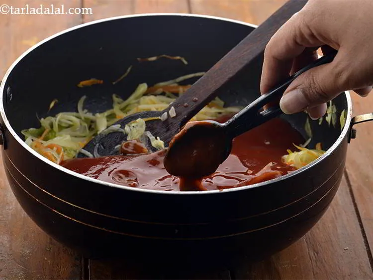 Step 26 – Add the chilli sauce, mix well and cook on a medium flame for 1 minute, …