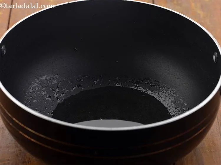 Step 16 – For making the chopsuey topping, heat the oil in a deep non-stick pan or wok.