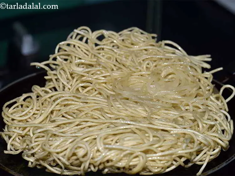 Step 9 – Once the bottom layer has turned golden brown, flip it using a pair of tongs.