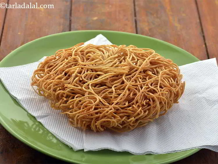 Step 12 – Drain on an absorbent paper. Similarly make one more batch of fried noodles.