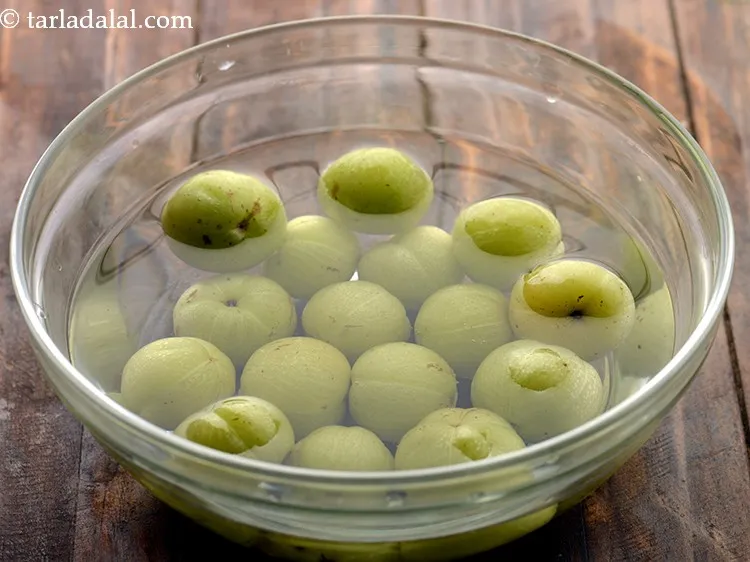 Step 2 – To prepare <strong>Rajasthani amla murabba</strong>, wash the gooseberries in a bowl or under running water. …