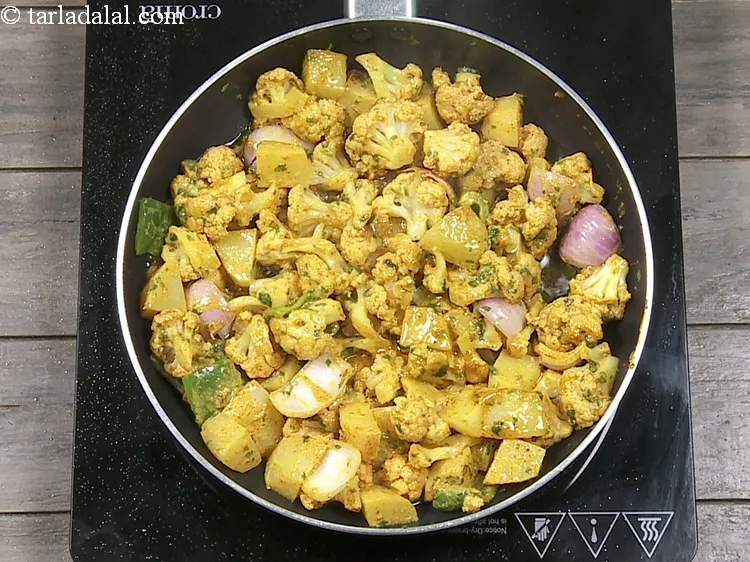 Step 23 – Cook on a slow flame for 2 to 3 minutes, while tossing it occasionally.