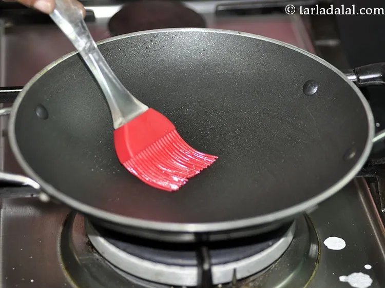 Step 19 – To cook the <strong>appam</strong>, heat an appachatti (appam kadhai) and grease it lightly with oil. …