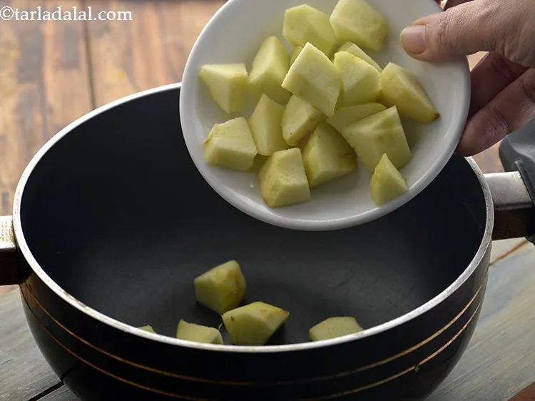 Step 14 – Transfer the chopped apple into a deep non-stick pan.&nbsp;