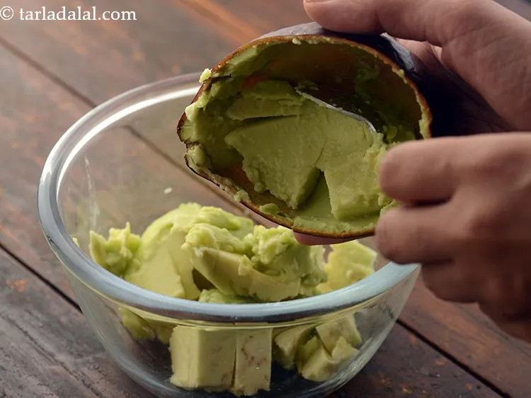 Step 10 – Scoop out the center portion of the avocado with the help of a spoon to …