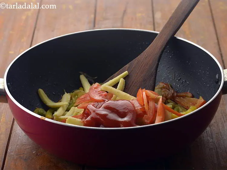 Step 13 – Also, add the tomato pur&eacute;e. We have used ready made tomato pur&eacute;e which is easily …