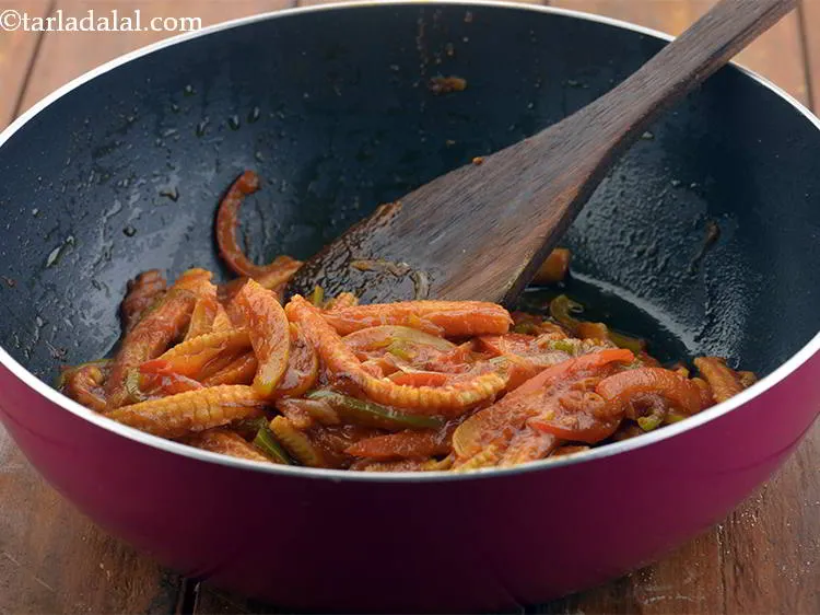 Step 13 – Also, add the tomato pur&eacute;e. This is simply made by boiling the tomatoes, peeling off …