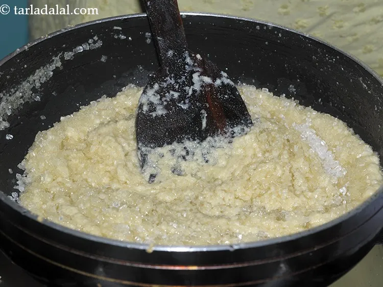 Step 23 – Sugar will start to melt and badam halwa will become runny again