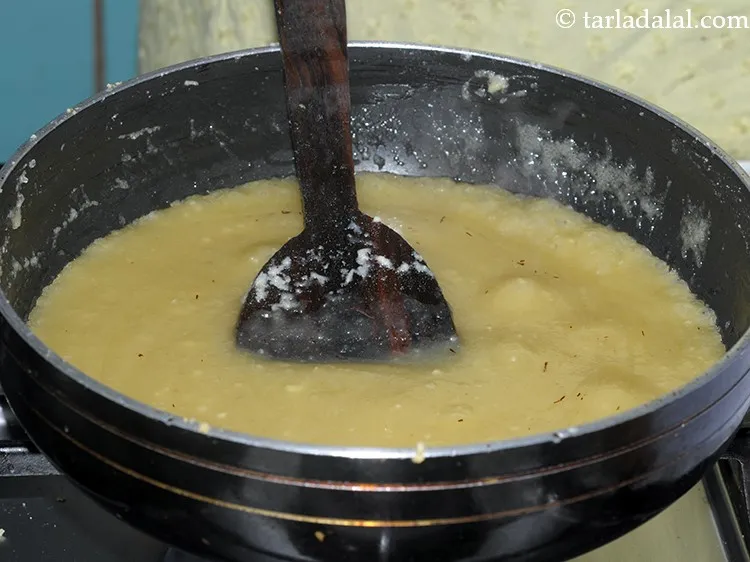 Step 26 – Mix well and cook almond sheera on a medium flame for 1 minute, while stirring …
