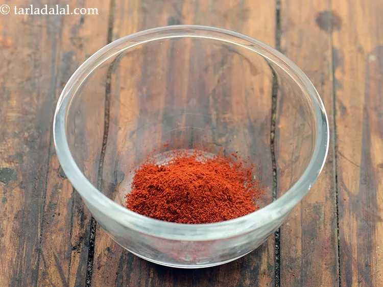 Step 2 – For the coating of <strong>Bengali begun bhaja</strong>, combine the chilli powder.
