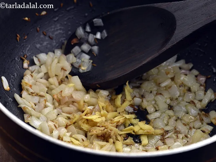 Step 10 – Add ginger. We have grated the adrak before adding to the <strong>Baingan Bharta.</strong>