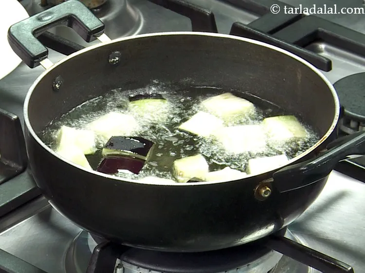 Step 3 – Once the oil is hot, deep-fry a few brinjal pieces on a medium flame. While …
