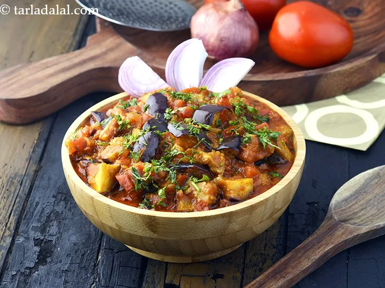 Step 26 – Serve <strong>baingan musallam</strong> hot garnished with coriander. <a href="https://www.tarladalal.com/Mughlai-Cauliflower-Potatoes-and-Green-Pea-Subzi-2183r" target="_blank"><strong>Mughlai cauliflower potatoes and green pea …