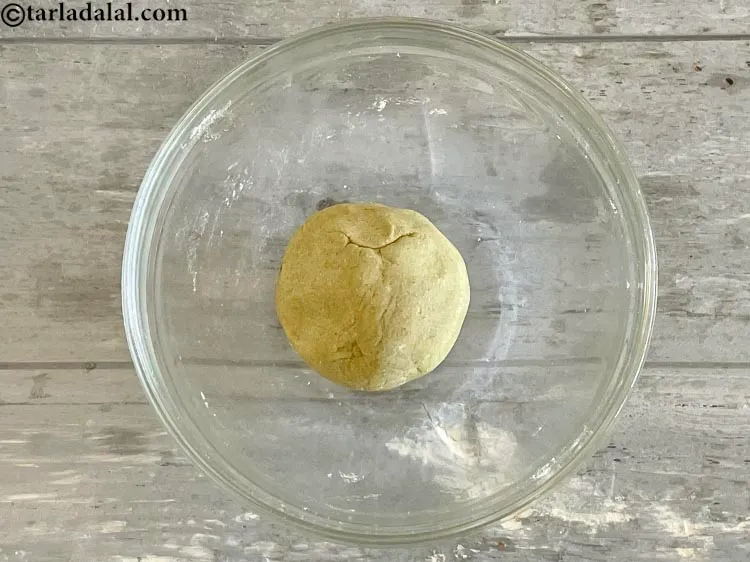 स्टेप 11 – एक सख्त आटा बनाने के लिए अच्छी तरह से गूंध …
