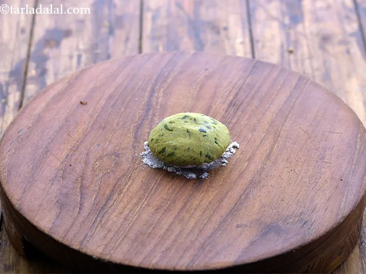 Step 26 – Take a portion of the dough and flatten it between your palms.