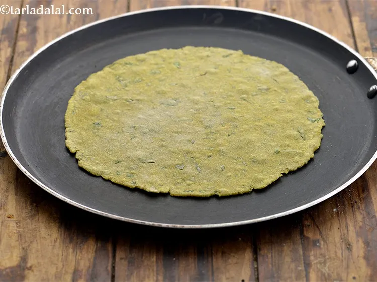 Step 17 – Heat a non-stick tava (griddle). Place the rolled out <strong>Khakhra</strong> dough on it and cook …