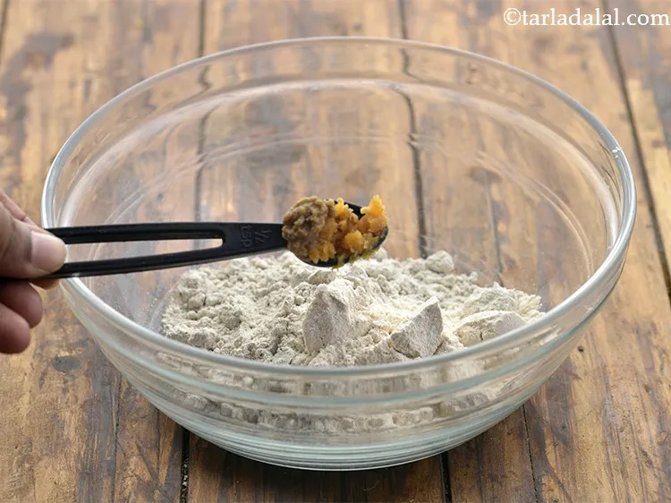 Step 6 – Add &frac12; tsp <a href="https://www.tarladalal.com/Ginger--Garlic-Paste-(-Popular-Restaurant-Recipes-)-33530r" target="_blank">ginger-garlic paste</a>. I have used homemade&nbsp;for this <strong>bajra khakhra recipe</strong>.