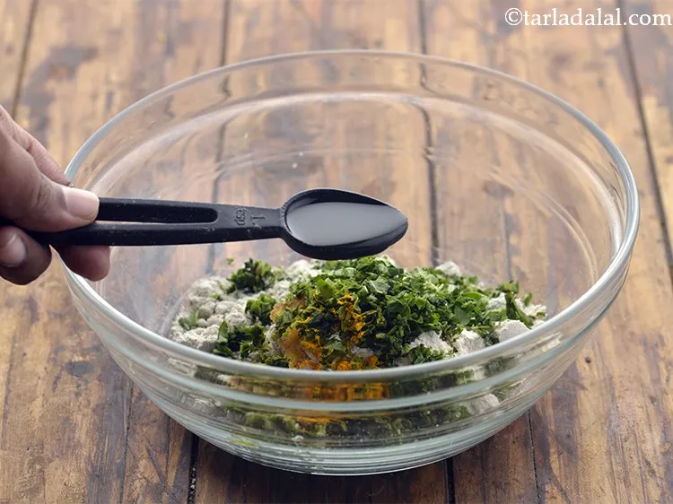 Step 10 – Add oil.&nbsp; It helps in making the <strong>bajra khakhra</strong> dough pliable.