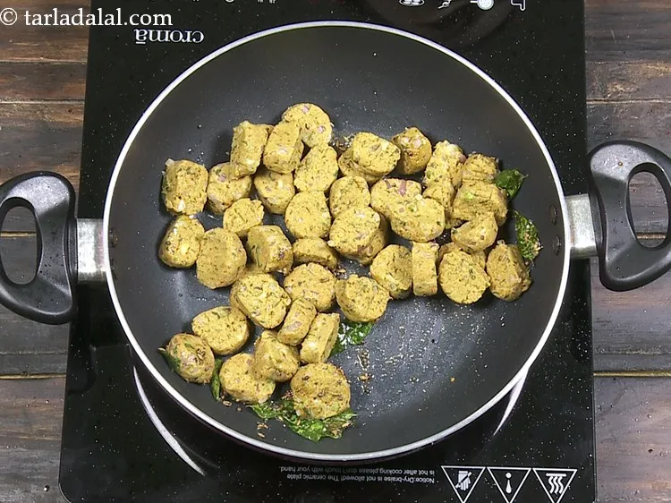 Step 28 – To the tempering, add the <strong>bajra onion muthia recipe | Gujarati bajra muthiya | healthy …