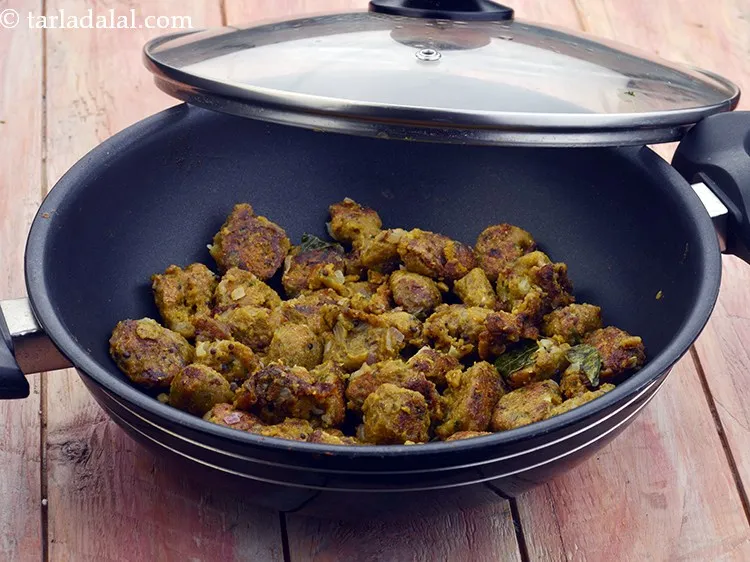 Step 34 – The muthia is cooked when all the water evaporates and it has turned slight brown …