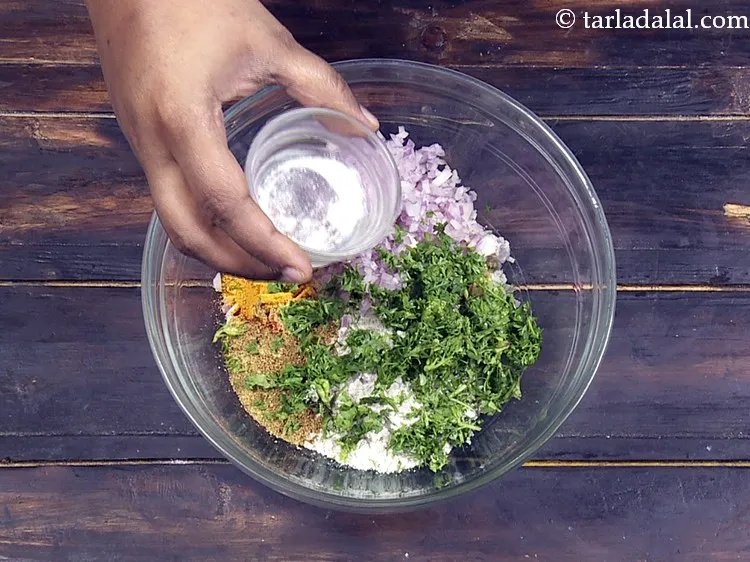 Step 10 – Add 2&nbsp;pinches of&nbsp;<a href="https://www.tarladalal.com/glossary-baking-soda-soda-bi-carb-615i">baking soda</a>. This is for the muthias to turn soft.&nbsp;