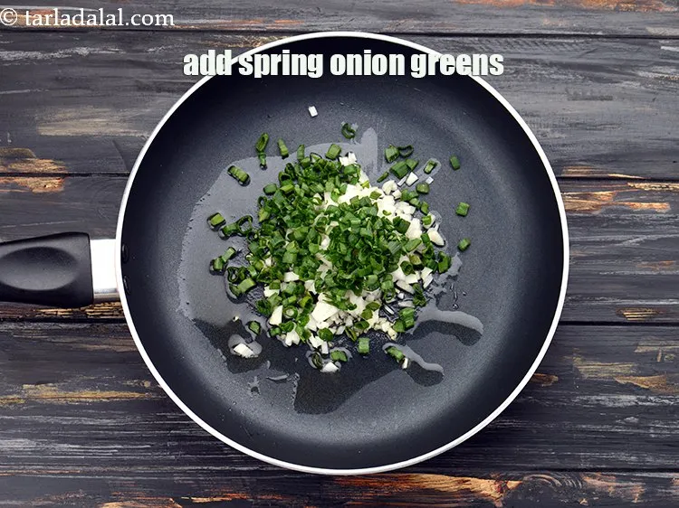 Step 8 – Add 1/4 cup&nbsp;finely&nbsp;<a href="https://www.tarladalal.com/glossary-chopped-spring-onion-greens-1030i">chopped spring onion greens</a>.