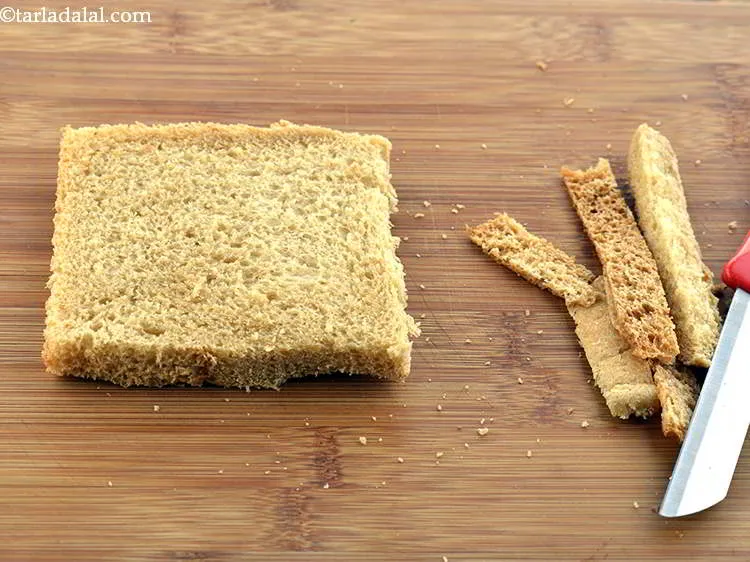 Step 23 – Place the bread slices on a claen and dry chopping board. Remove the crust from …