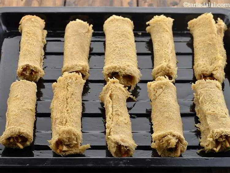 Step 29 – Place the rolls on a greased baking tray. Grease the baking tray well so that …
