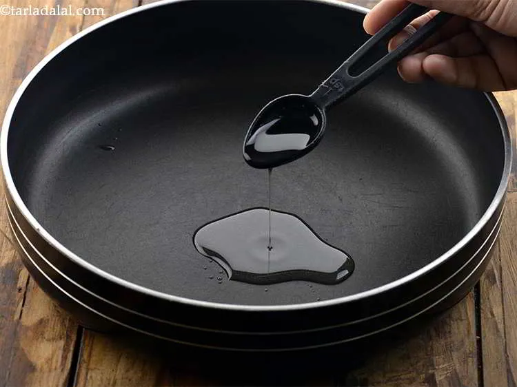 Step 10 – To make the stuffing for the <strong>Baked bread rolls</strong>, heat the oil in a broad …