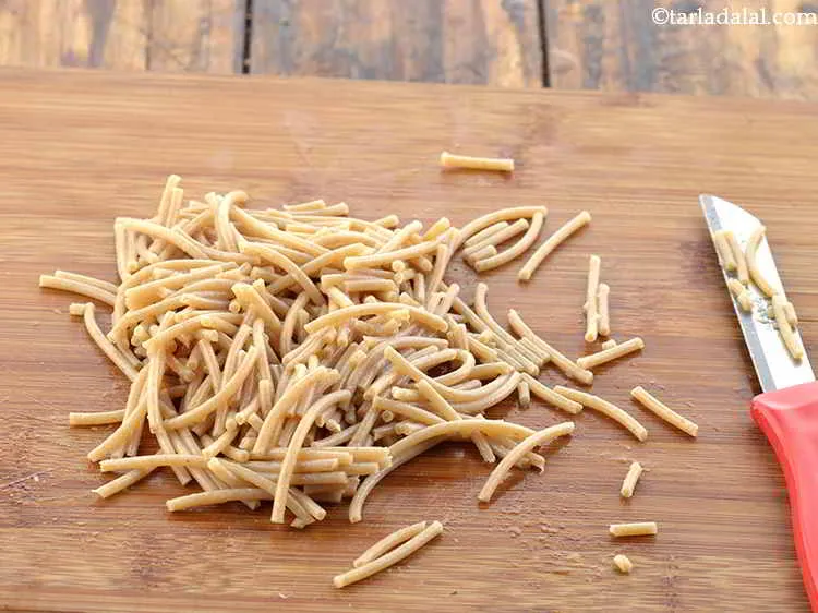 Step 9 – Cool the noodles slightly and transfer them to a chopping board. Chop the noodles up …