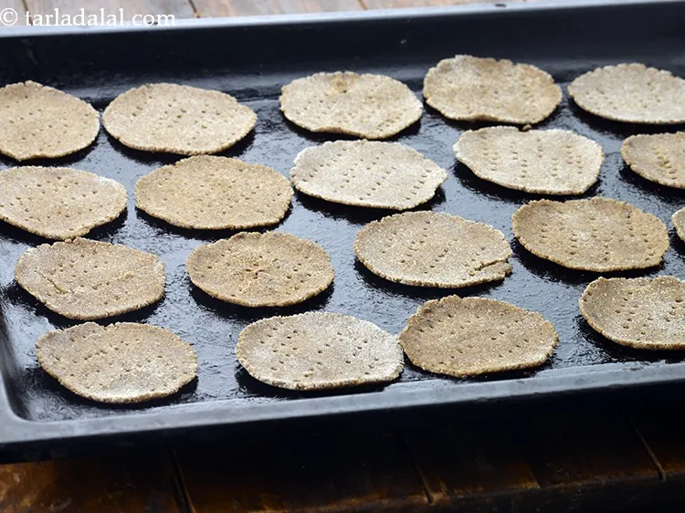 Step 12 – Arrange them on a greased baking tray and prick each puri with a fork at …