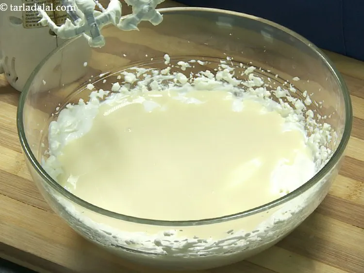 Step 12 – Add the milkmaid to sweeten up the <strong>gulab jamun laddu cheesecake</strong>.