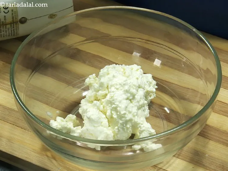 Step 8 – For the<strong> eggless Baked gulab jamun cheesecake </strong>mixture, in a deep bowl take cream cheese. …